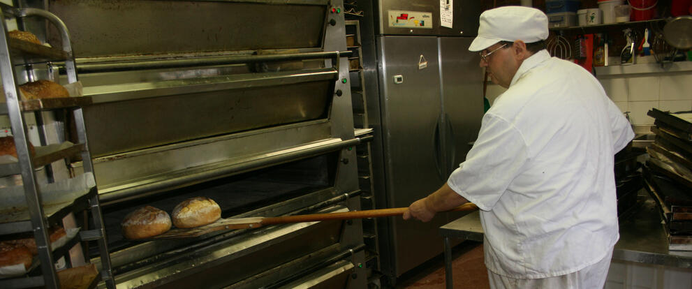 Taking out the freshly baked bread