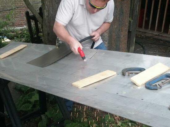 Shaping a new waterwheel lining plate with a plasma cutter